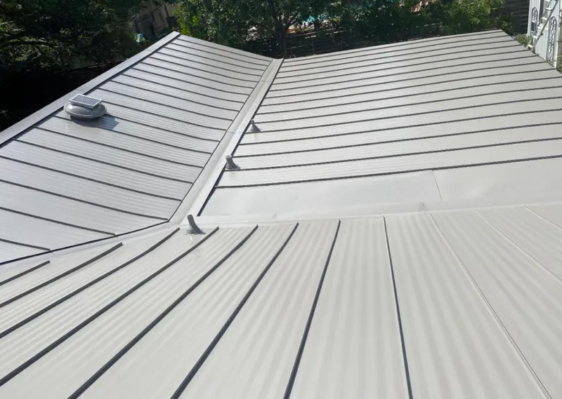Solar attic fan installed on a metal roof for Roof Ventilation in Boston